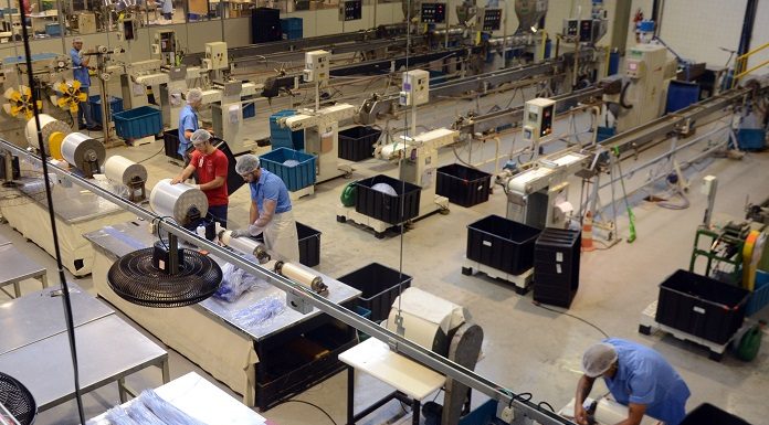 linha de montagem de ventiladores vista de cima com alguns operários trabalhando