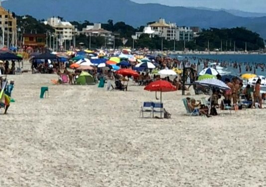 centenas de pessoas na praia de canasvieiras